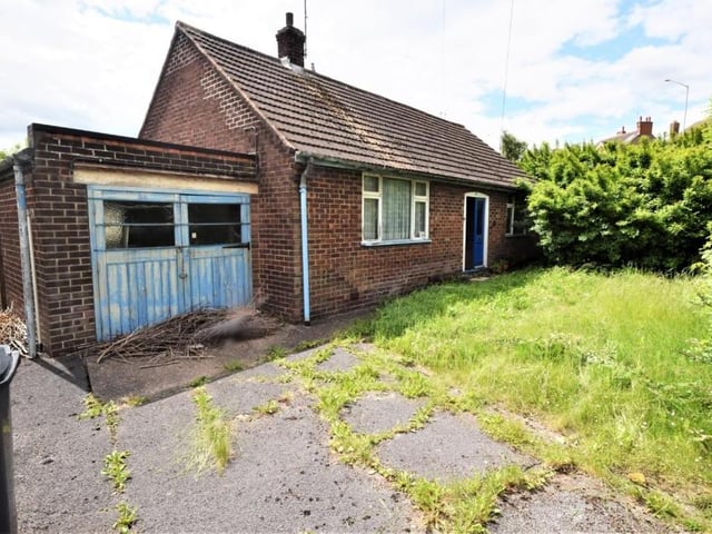 Returning outside, this is a wider shot of the front of the £144,000 bungalow. The property is accessed via double gates.