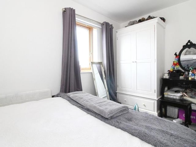 An image showing there is plenty of storage space in the second bedroom, and also room for a dressing table.