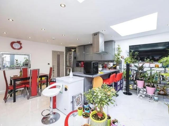 A second shot of the sizeable kitchen diner, which shows a breakfast bar and the dining area.