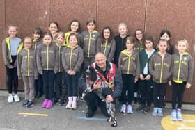 Members of 2nd Kirkby Brownies with Dexter, the fire investigation dog, and his handler Dave Cross.