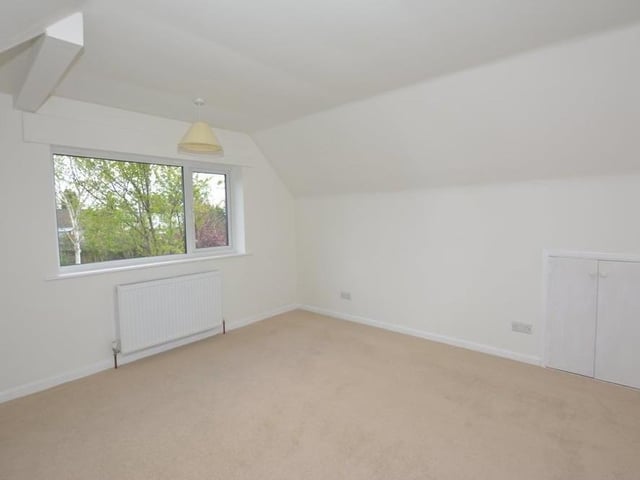 The other first-floor bedroom is a good, versatile space, enabling you to put your stamp on it. The window faces the front, and the eaves storage houses a recently installed Baxi central heating boiler.