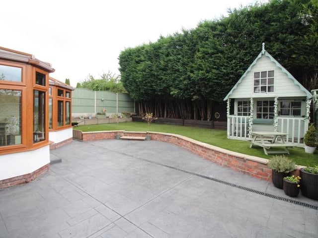 The garden at the back of the house is low-maintenance but attractive. The patio area leads to an artificial lawn, while the whole space is enclosed by conifers and timber fencing, with a gate offering side access.
