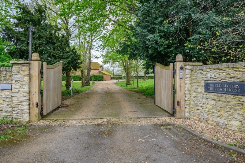 These gates lead you into this large property set across nearly four acres of land
