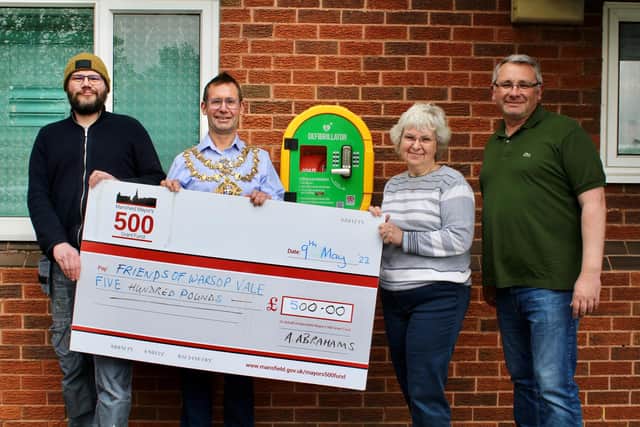 Executive Mayor Andy Abrahams, whose £500 donation helped fund a community defibrillator in Warsop Vale pictured with (left to right) Tim Fisher, of Mierce Miniatures, which is funding power to the defibrillator, Sharon Scott, a volunteer with the Friends of Warsop Vale, and Coun Andy Burgin, ward councillor for Warsop Carrs