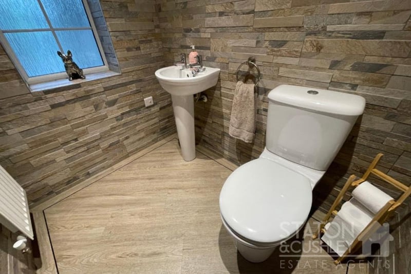 There is a handy downstairs toilet at the Kirkby property. It includes a low-level WC, pedestal sink, tiled walls and LVT flooring.