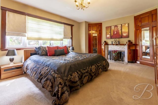 The largest of the four bedrooms has the luxury of well-appointed, fitted wardrobes and also an original Italian fireplace, made of marble and walnut. The double-glazed window overlooks the back of the property.