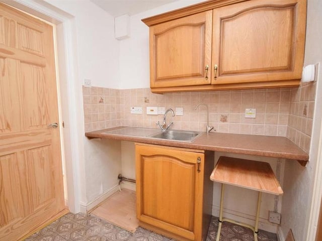 This useful utility room is fitted with wall and base units for storage, with a work surface over and inset stainless steel sink and drainer. There is space and plumbing for a washing machine, and space for a tumble dryer.