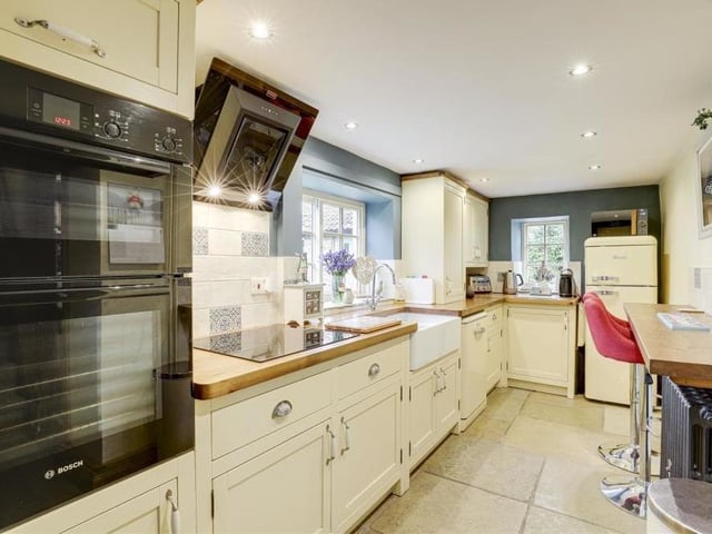 Our tour of the interior begins in the breakfast kitchen, which features an integrated Bosch double oven and an electric hob with angled extractor fan. There is also a cute breakfast bar, a Belfast sink with a swan-neck mixer tap and space for a fridge/freezer.