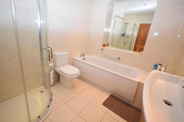As well as the en suite facilities, the first floor hosts this sparkling family bathroom. It consists of a panelled bath, separate shower cubicle, low-flush WC, wash basin in vanity unit, chrome heated towel-rail, tiled flooring and tiled walls.