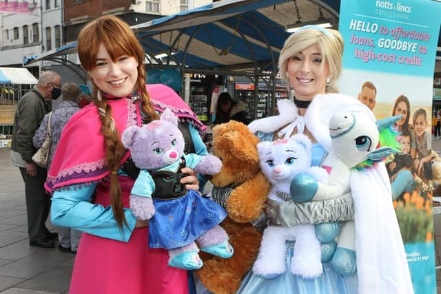 Party princesses Anna and Cinderella show off some of the teddy bears and soft toys on the credit union stall, which raised money for Mansfield Soup Kitchen.