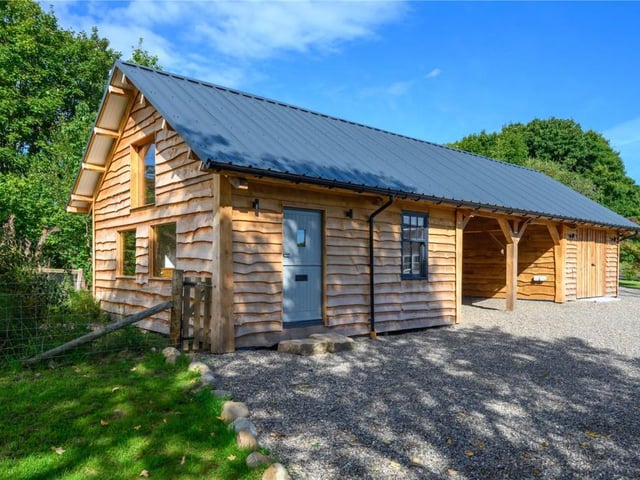 The timber framed outbuilding was constructed using traditional techniques and locally sourced Douglas Fir beneath a box profile roof.