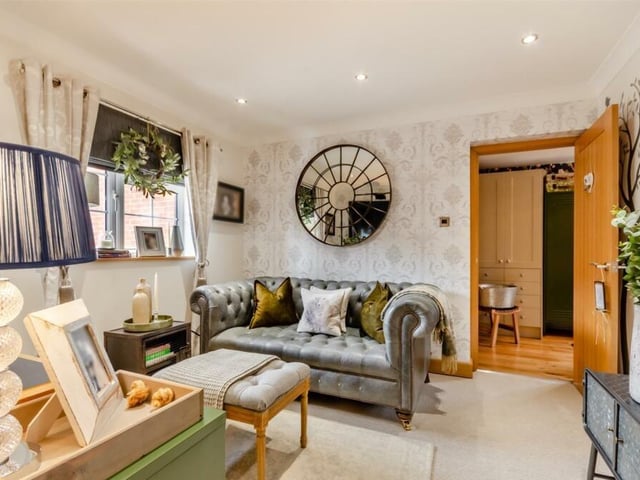 The next reception room at the £465,000 Sutton property to take a look at is this cosy snug, which has seven ceiling spotlights, a contemporary cast-iron anthracite radiator, coving to the ceiling and a window to the front of the house.