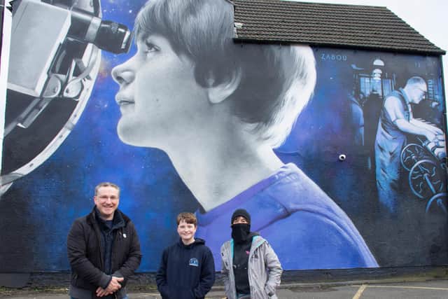 Ashfield District Council's Matthew Relf, Cabinet Member for Planning and Regeneration, with Freya, the girl in the mural, and Zabou, the artist