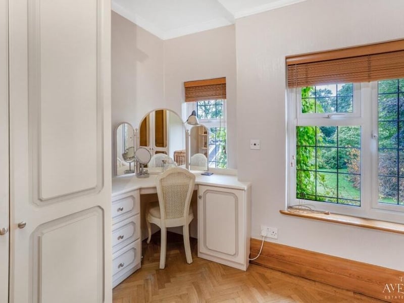 A quiet but characterful corner of a bedroom with space for a dressing table.