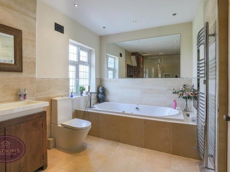 The main feature of the luxurious family bathroom is this fitted whirlpool bath, complete with mains-fed shower.