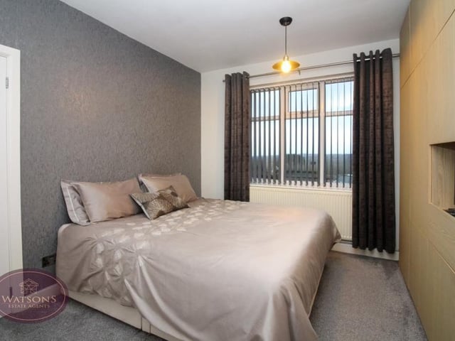 This is the main bedroom with ample space for a double bed, as well as floor-to-ceiling and wall-to-wall wardrobes.The window overlooks the back of the bungalow.