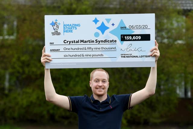 Craig Rowland with the EuroMillions winning cheque. Photo: Sam Bagnall