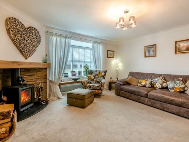A focal point of the lovely lounge is a feature fireplace with log-burner, slate hearth and backing, complemented by an oak mantelpiece above.