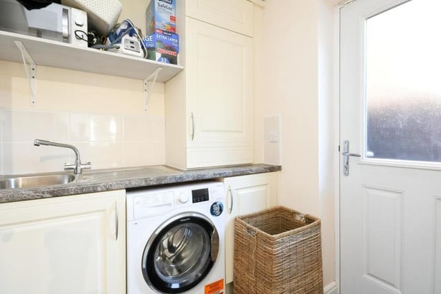 This handy utility room, just off the kitchen, has space and plumbing for a washing machine.