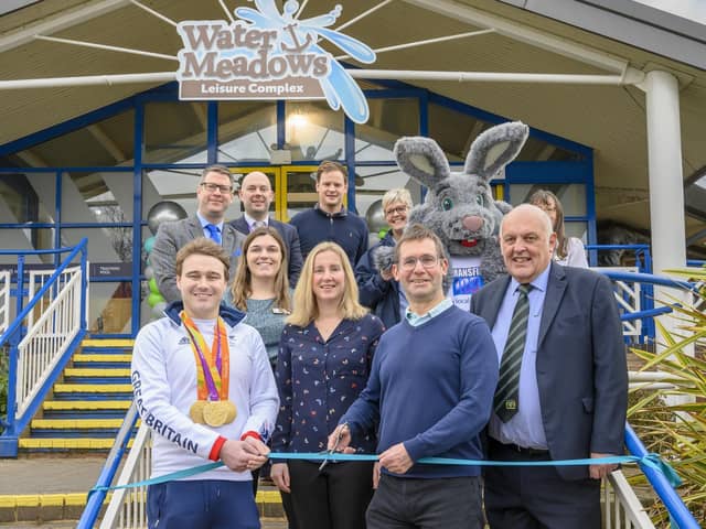 Andy Abrahams, Mansfield mayor, cuts a ribbon at the ceremony. Dignitaries gathered to mark the reopening of Mansfield's Water Meadows Leisure Complex.