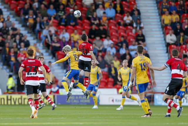 Aaron Lewis leaps well for Mansfield during the Sky Bet League 2 match against Doncaster Rovers FC at the Eco-Power Stadium  
Photo Chris & Jeanette Holloway / The Bigger Picture.media