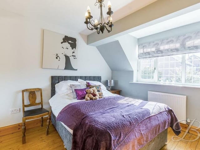 Bedroom number three is a quaint space that faces the back of the property. Fitted wardrobes and wood flooring add to its appeal.