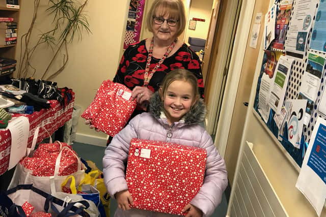 Lilly-May dropped off her wrapped gift donations at Eastwood Food Bank yesterday.