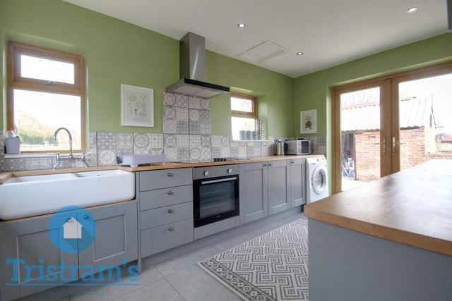 The stylish kitchen is an open space, featuring a wealth of base and wall cupboards, complete with under-unit lighting. There are solid work surfaces throughout, plus space for an oven cooker, with ceramic hob above.