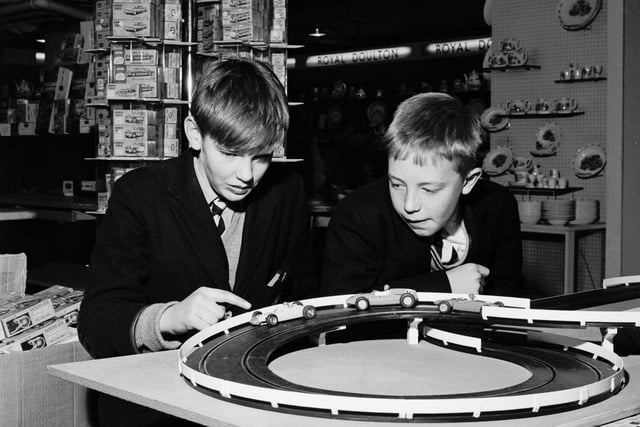 Schoolboys playing with a slot-car racing set called Trix  in the toy department of Binns department store in Edinburgh, November 1965.