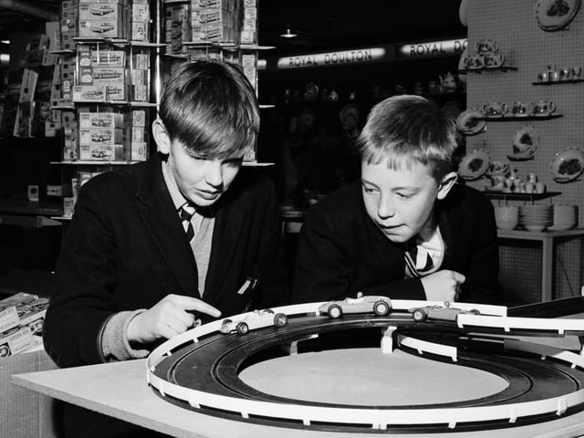 Schoolboys playing with a slot-car racing set called Trix in the toy department of Binns department store in Edinburgh, November 1965.