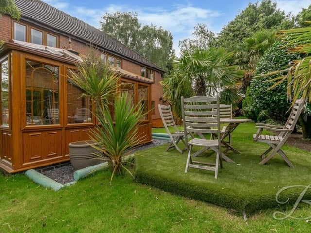 Here is another charming seating area in the garden, outside the conservatory.