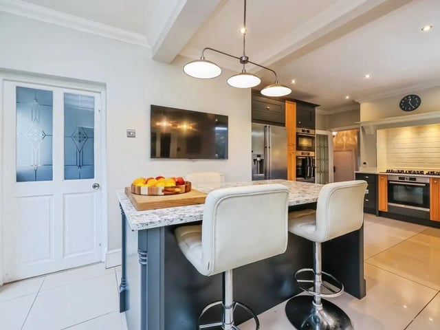 The kitchen features an island that doubles as a breakfast bar.