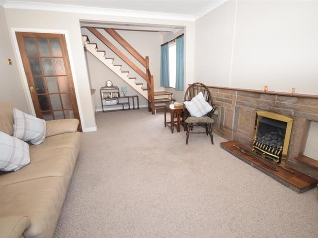 A second shot of the lounge diner, which features a staircase leading to the first floor. Plenty of natural light flows through uPVC windows at both the side and front.