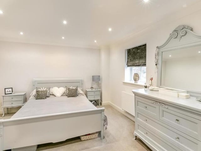 The third bedroom at the Mayflower Court property is so spacious that there is space for a dressing table and various other furniture. It also features two sets of fitted wardrobes, coving to the ceiling and a window overlooking countryside at the back of the house.