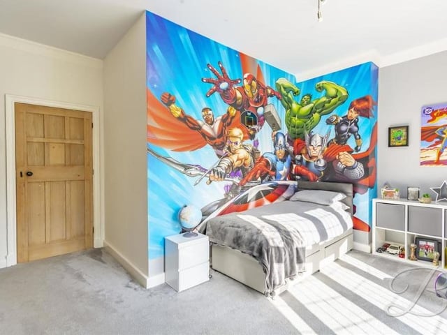An action-packed bedroom suitable for Superman! Clearly one for the kids, it has a carpeted floor and bay window.
