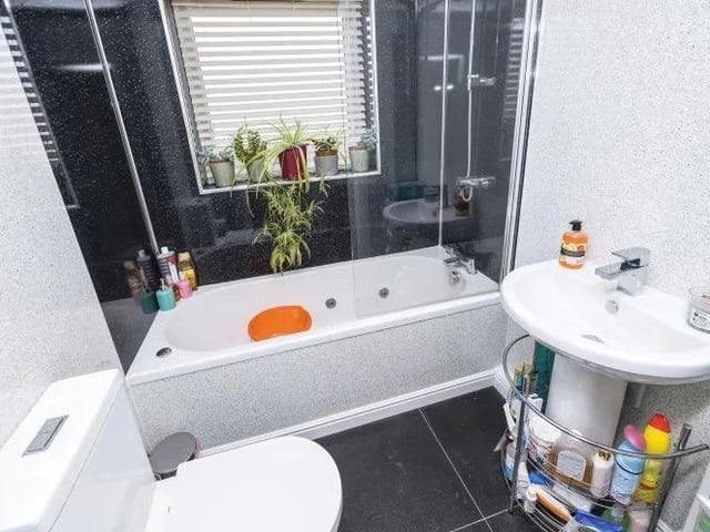 Here is the first-floor bathroom, consisting of Jacuzzi with overhead shower, glass door, wash hand basin and WC.