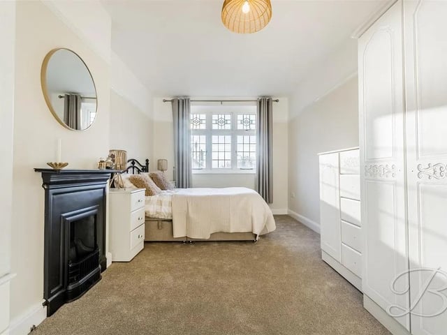This double room is carpeted with a feature fireplace and window to front elevation.