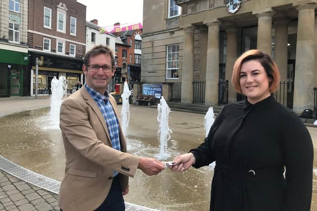 Jenna Simpson receives the keys to her new salon from Andy Abrahams, Mansfield mayor, outside the Old Town Hall.