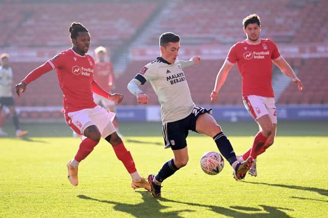 Harry Wilson is challenged by Gaetan Bong and Scott Mckenna. (Photo by Laurence Griffiths/Getty Images)