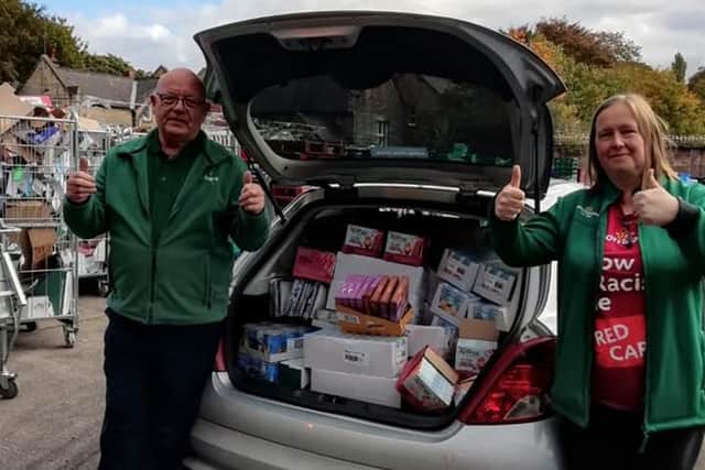 The foodbank's stock manager, Owen, pictured collecting donations from Amanda, Community Champion at Morrisons at Mansfield Woodhouse