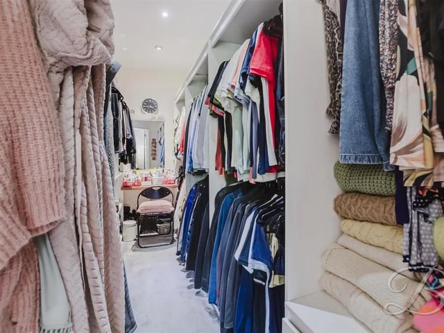 A stunning walk in wardrobe provides plentiful storage and added convenience