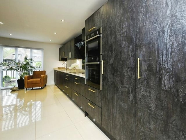 A different view of the kitchen, which also boasts a double oven with microwave, fridge freezer, double wine fridge and integrated dishwasher. As well spot lighting, there is under-counter and plinth lighting, while the whole open-plan space benefits from a tiled floor and underfloor heating