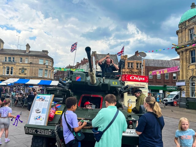 Families admiring a real army tank.