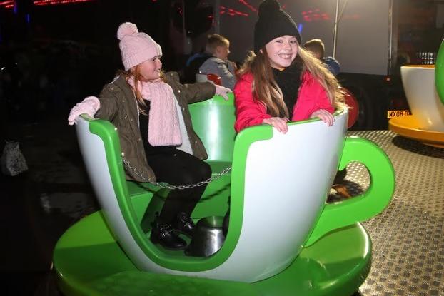 Sisters Elsie and Charlie Laykin share a smile on the classic teacup ride during the 2019 festivities