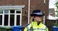 Police standing guard outside the murder scene