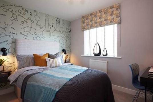 Jones Homes's inspiration behind this fourth bedroom was a young teenager who is fascinated by science. The company chose wallpaper that reflects the kind of sketches the teens may do in their notebook, while floating bedsides and cordless wall-lamps give the room a modern feel.