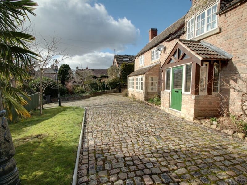 Back to the front of the house now and this photo shows how the attractive driveway, which offers plenty of space for off-street parking, leads to to the front door and porch.