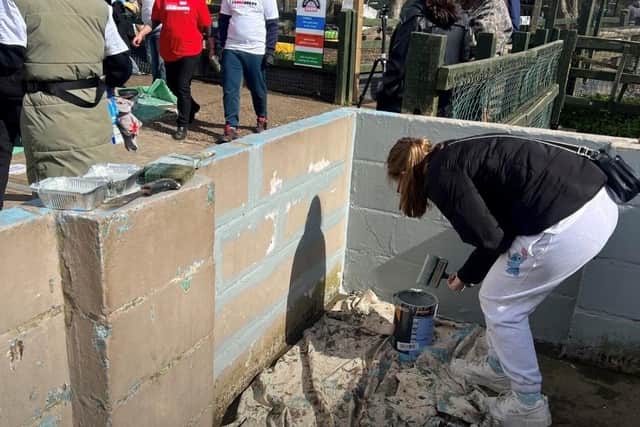 One learner helps refresh one of the outdoor spaces