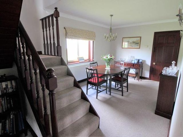 The dining room, which faces the back of the Ollerton property, from a different angle. The staircase leads to the first floor.