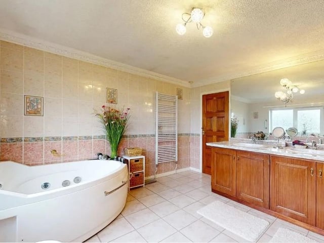 A 14ft family bathroom with six piece suite comprising a corner jacuzzi style bath